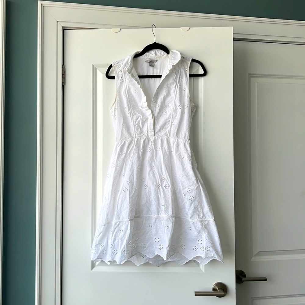 White shortsleeved eyelet dress.